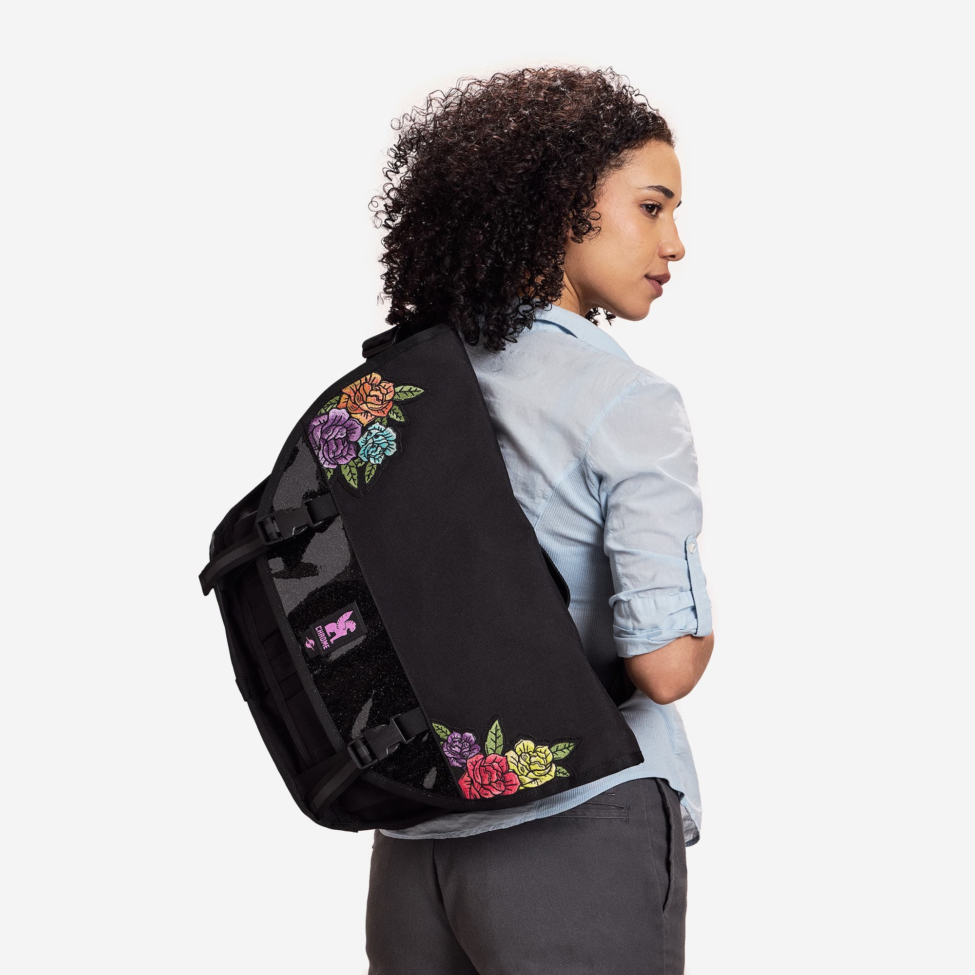 A woman wearing the Chrome x Rio Pride Citizen 15L in Rio Black Rose #color_rio rose black