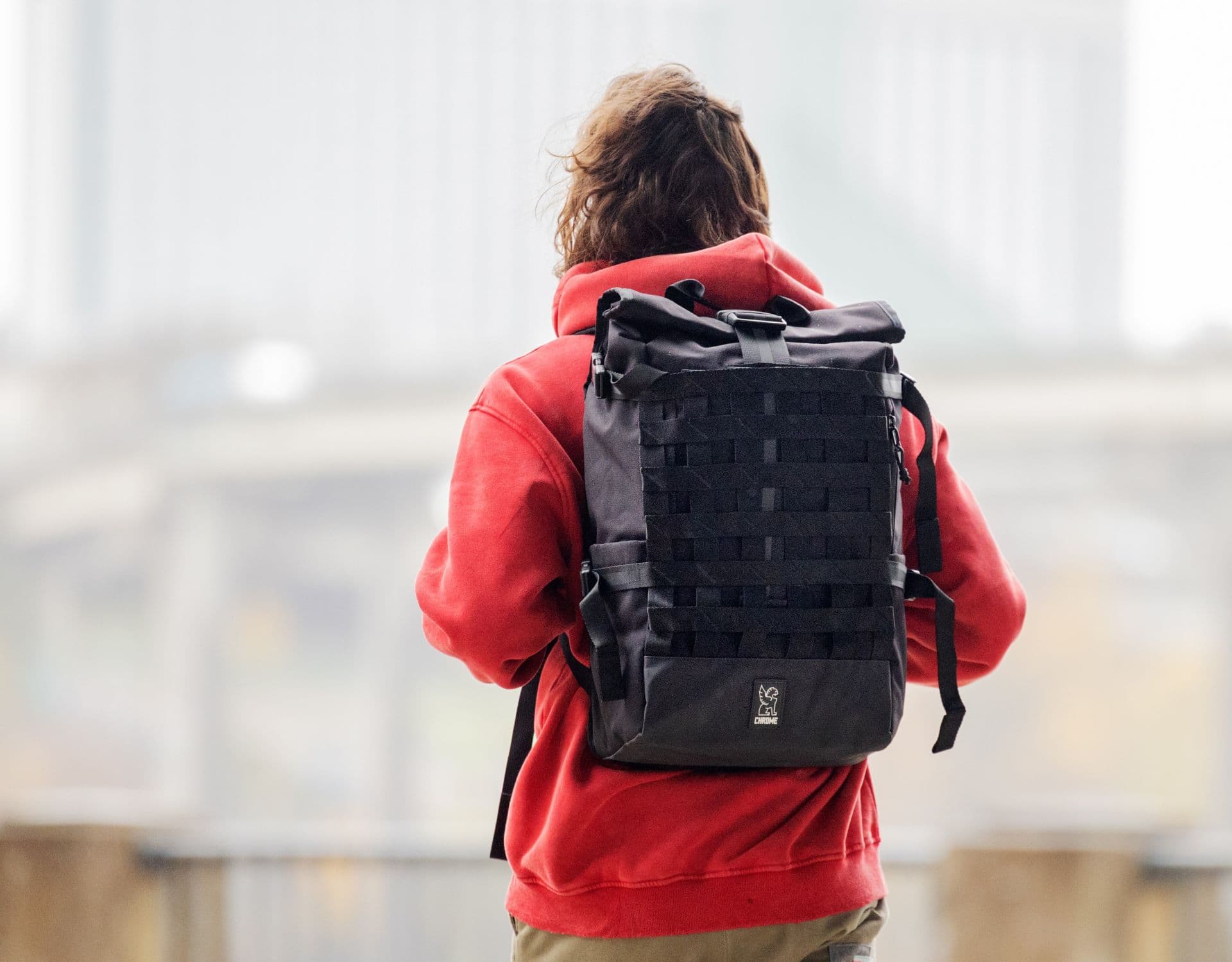 Guy in a red sweatshirt wearing the Barrage Backpack