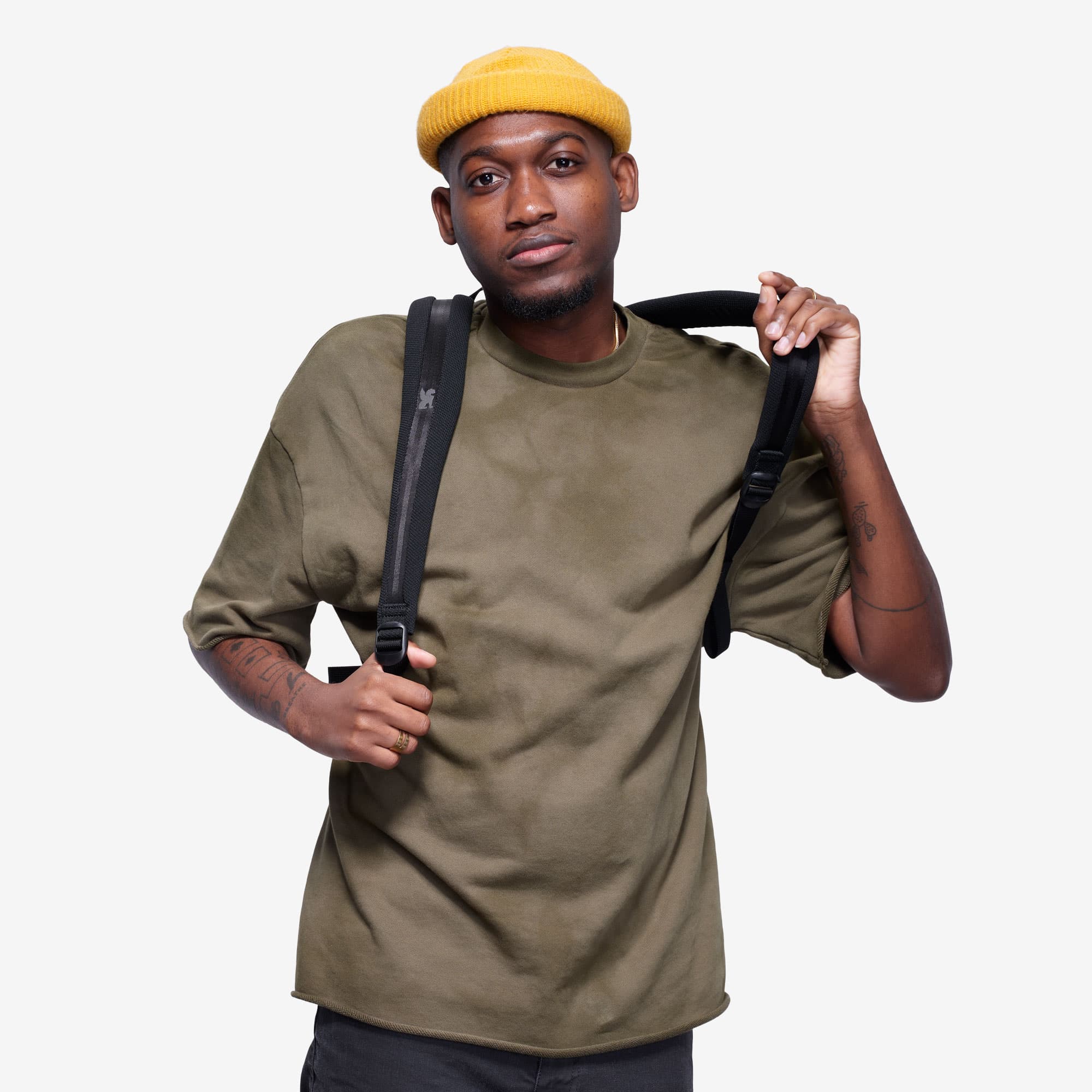 Camden backpack in black on a person front strap view