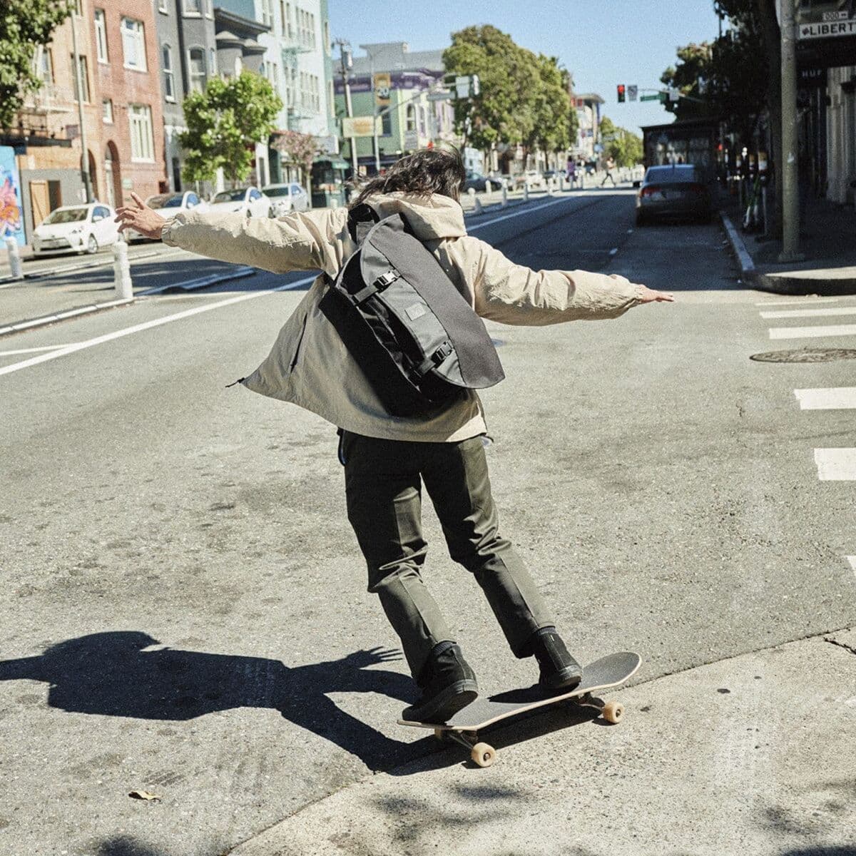 A guy skateboarding with the Citizen on his back