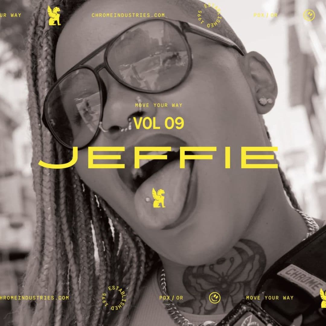 Jeffie with their tongue sticking out, glasses on