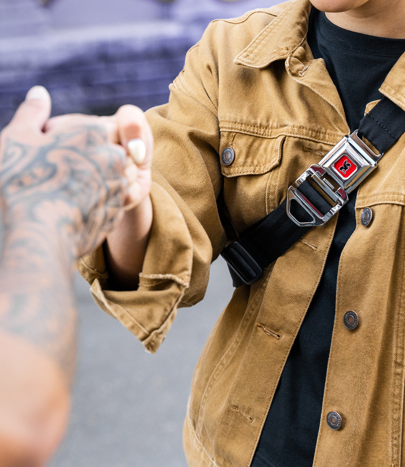 Person wearing an iconic Chrome Buckle bag shaking hands mobile image size