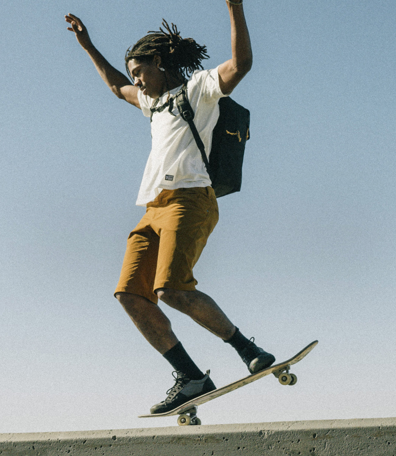 Person on a skateboard jumping mobile image for contact page